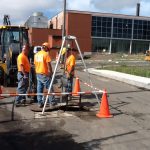 HG&E workers installing optical fiber in the conduit beneath Bigelow Street near the data center - Aug 15