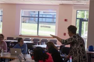 Springfield middle school teacher Maureen Moynihan discusses an experimental cloud computing module about weather and climate processes with educators from local schools and community organizations. (Image Credit: Matthew Mattingly)